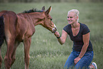 woman and Oldenburg Horse foal