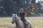 woman with horse and Eurasian eagle owl