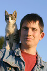 man with young cat