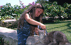 girl feeds cat