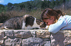 girl feeds cat