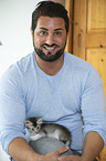 man with Somali Kitten