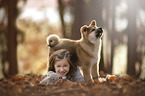 girl with Akita Inu puppy