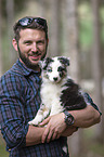 man with Australian Shepherd Puppy
