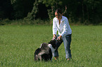 woman plays with dog