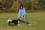 woman is playing with Border Collie