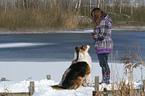 woman with 2 dogs in the snow