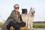 woman with Border Collie and White Shepherd