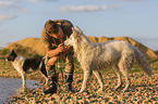 man with Border Collie and White Shepherd