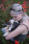 woman with Border Collie in the poppy field