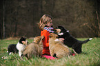 girl and longhaired Collie puppies
