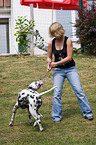 woman plays with dog