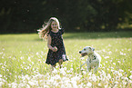 girl plays with Dalmatian