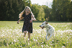 girl plays with Dalmatian