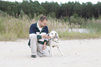 man plays with dalmatian