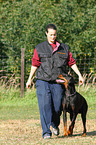 woman and Doberman Pinscher