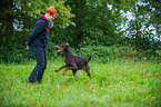 woman and Doberman Pinscher