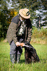 man with Flat Coated Retriever