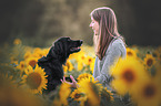 woman and Flat Coated Retriever