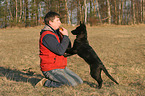 man and young German Shepherd
