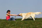 woman plays with Golden Retriever