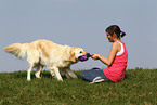 woman plays with Golden Retriever