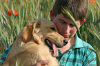 man and young Golden Retriever