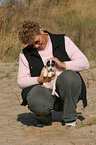 woman fondles Jack Russell Terrier Puppy