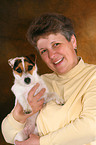 woman carries Jack Russell Terrier