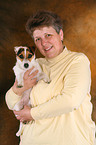 woman carries Jack Russell Terrier