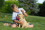 boy with labrador retriever puppy