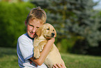 boy with labrador retriever puppy