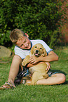 boy with labrador retriever puppy