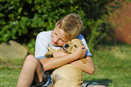 boy with labrador retriever puppy