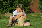 boy with labrador retriever puppy