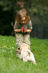 girl with Labrador Retriever puppy