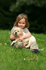 girl with Labrador Retriever puppy