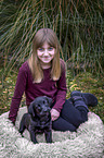 girl with Labrador Retriever Puppy