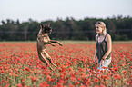 woman with  Malinois in the poppy field