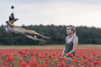 woman with  Malinois in the poppy field