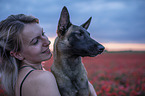 woman with Malinois in the poppy field