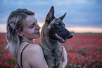 woman with Malinois in the poppy field