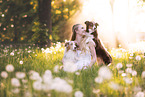 young woman with 2 Miniature Australian Shepherds