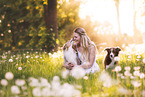 young woman with 2 Miniature Australian Shepherds