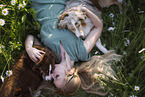 young woman with 2 Miniature Australian Shepherds