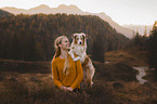 young woman with Miniature Australian Shepherd