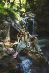 young woman with 2 Miniature Australian Shepherds