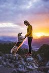 young woman with Miniature Australian Shepherd