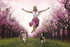 young woman with 2 Miniature Australian Shepherds