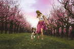 young woman with Miniature Australian Shepherd